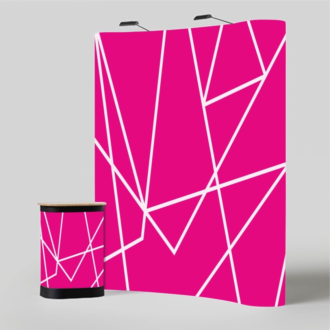 Curved pop-up display stand with a pink printed graphic backdrop and matching counter, showing an immersive exhibition display system for branded events.
